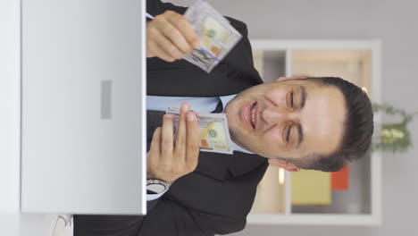 Vertical-video-of-Home-office-worker-man-proud,-money-happiness.